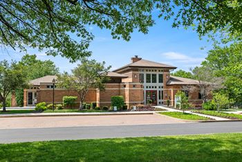 A house with a brick facade and a large front porch.